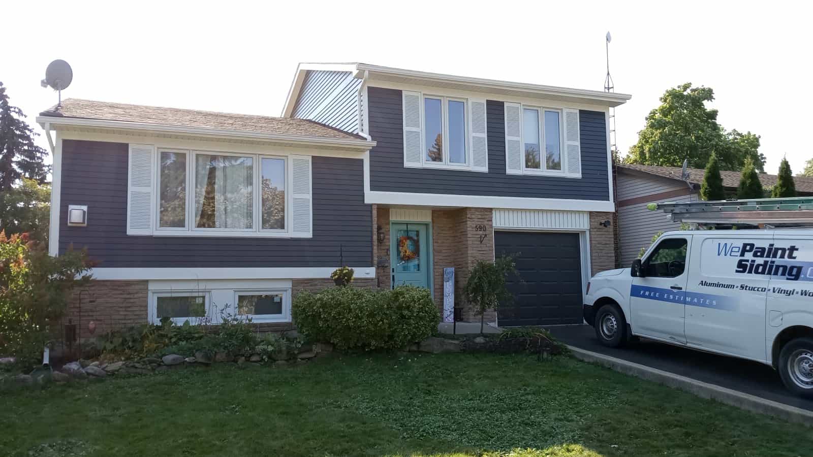elegant looking house in Niagara Falls with We Paint Siding van in front.