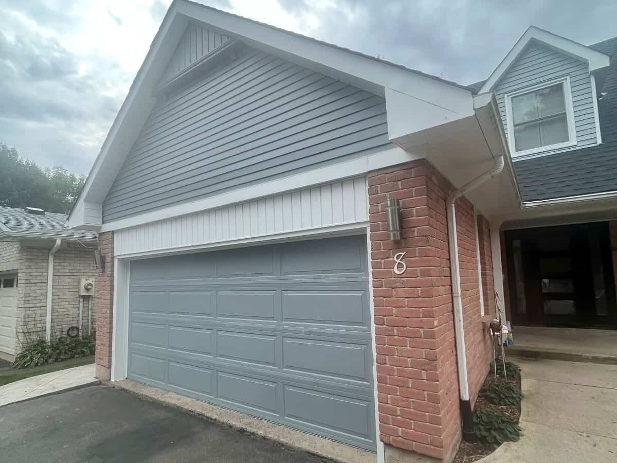 freshly painted aluminum siding and garage door on a house.