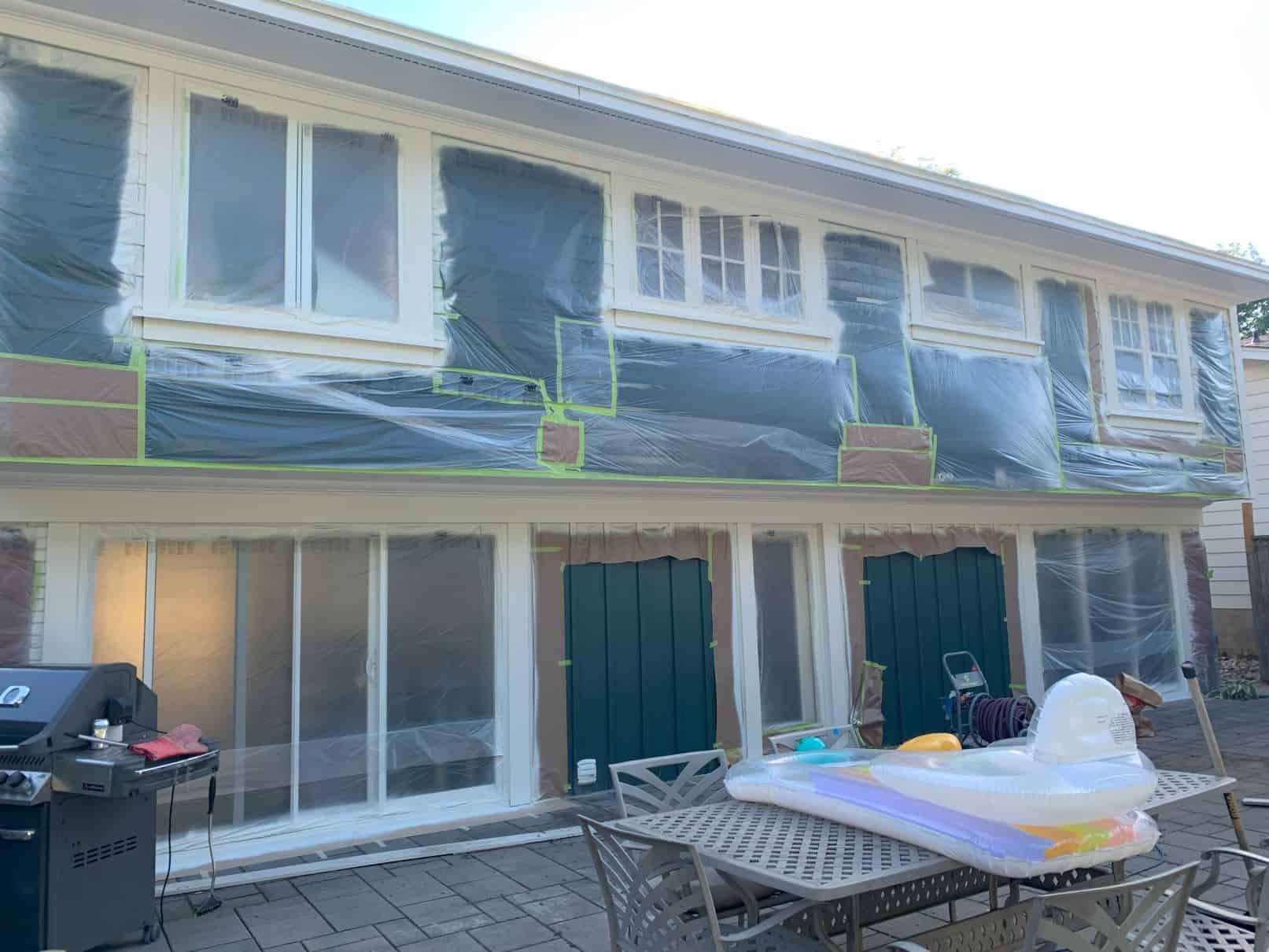 extensive masking on the back of a house for spray painting exterior windows.