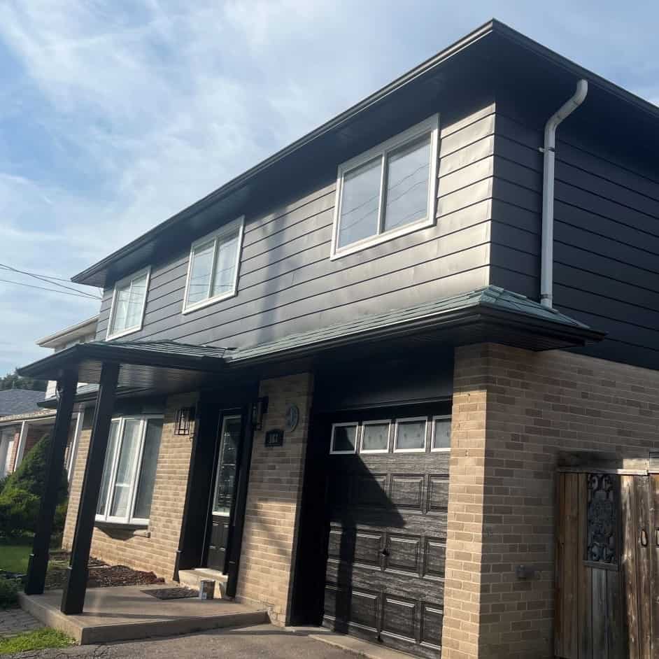 house in St. Catharines with trim, siding, windows, painted in black.
