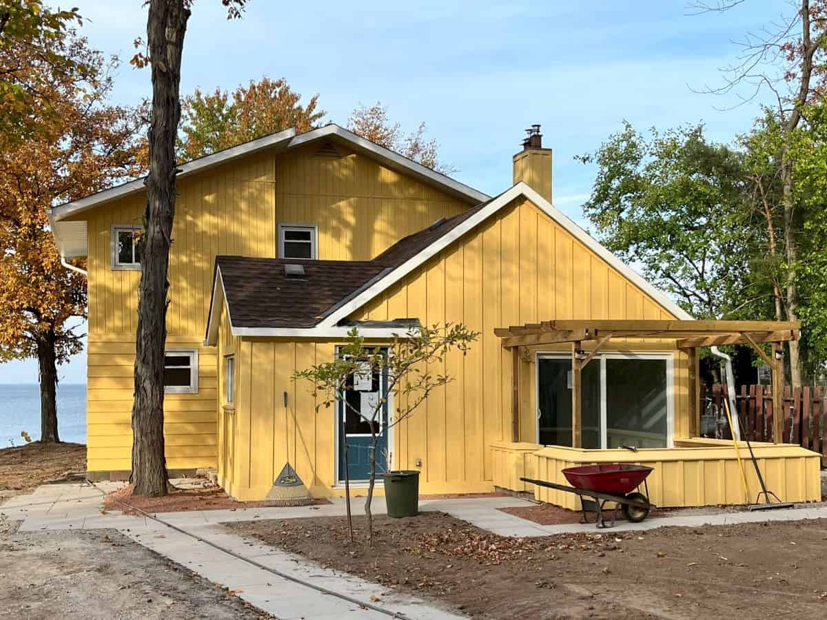 Yellow house on Lakeshore in Oakville after spray painting.